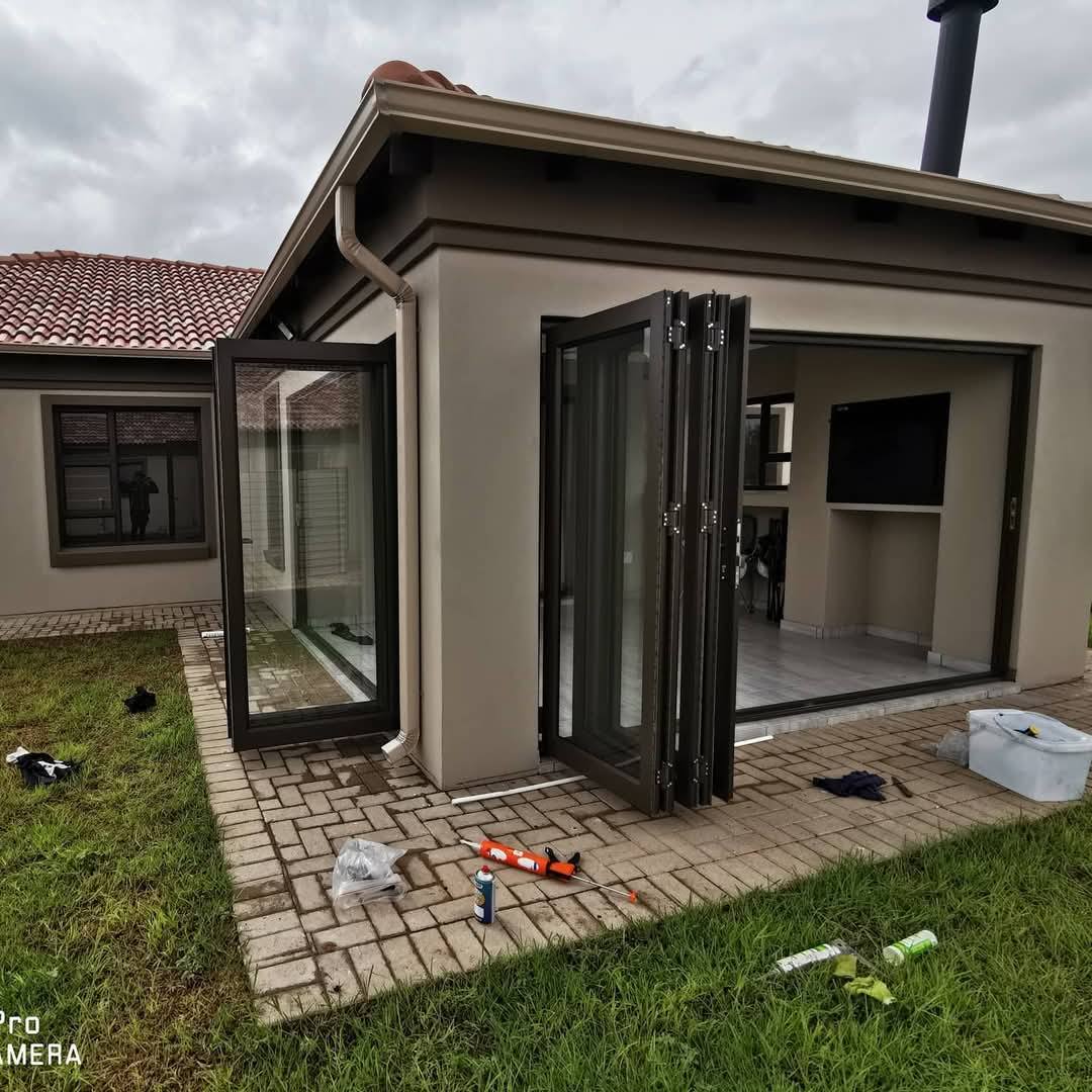 Aluminium stack doors installed on a residential property, offering a modern, durable, and elegant finish.